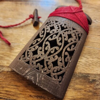 front image of sandalwood toki necklace with red binding